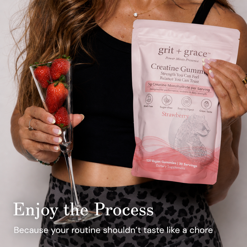 Woman holding a glass of fresh strawberries and a pouch of Grit + Grace Strawberry Creatine Gummies, captioned Enjoy the Process